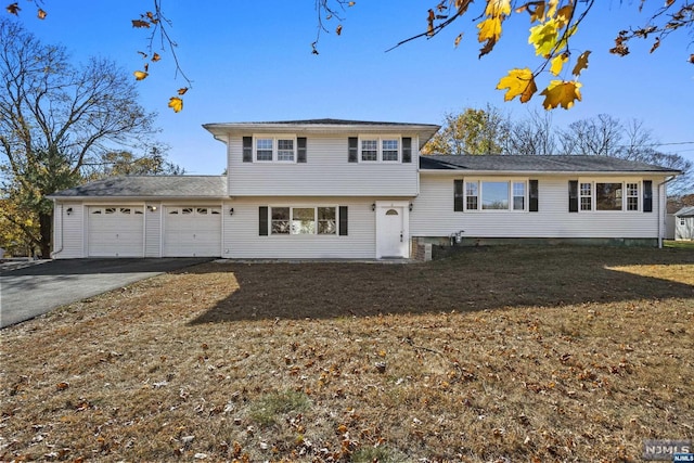 split level home with a front yard and a garage