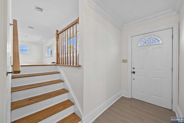 foyer featuring light hardwood / wood-style floors and ornamental molding