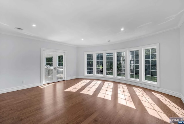 empty room with french doors, wood-type flooring, and ornamental molding