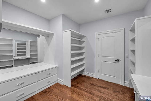 walk in closet featuring dark hardwood / wood-style floors