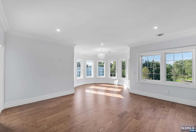 unfurnished living room featuring a chandelier, crown molding, and wood-type flooring