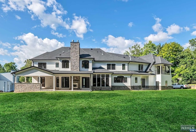 rear view of property with a yard