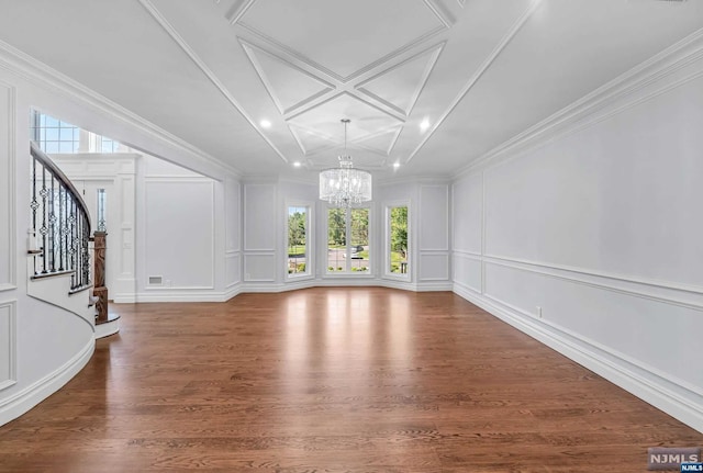 unfurnished living room with a notable chandelier, wood-type flooring, and ornamental molding