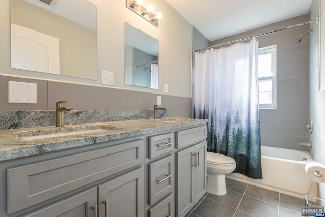 full bathroom featuring tile patterned floors, vanity, toilet, and shower / bath combo