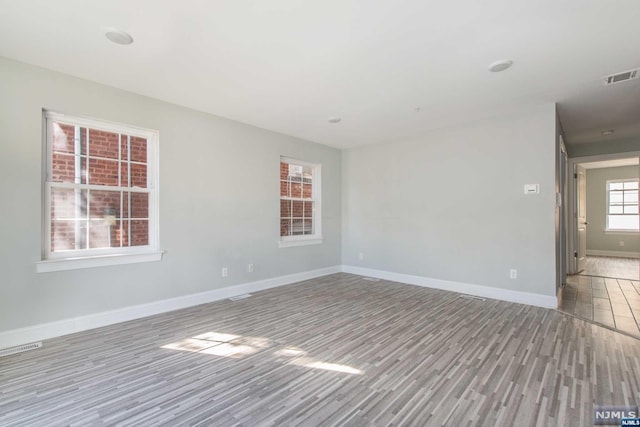 unfurnished room featuring light hardwood / wood-style floors