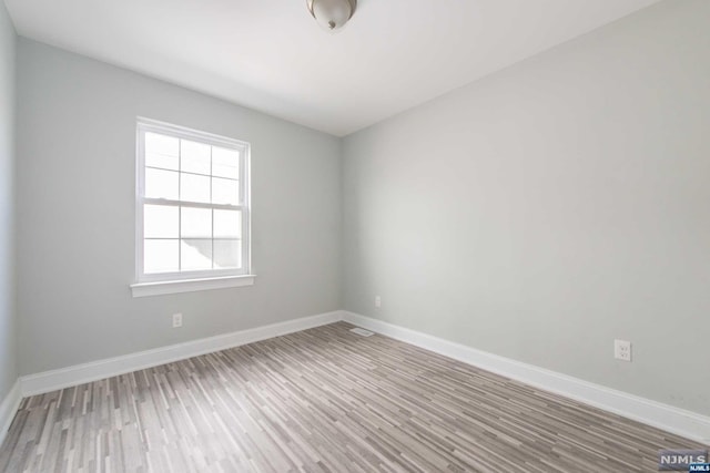 empty room featuring wood-type flooring