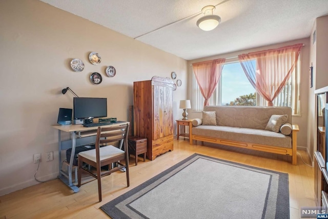 office space featuring light hardwood / wood-style floors and a textured ceiling