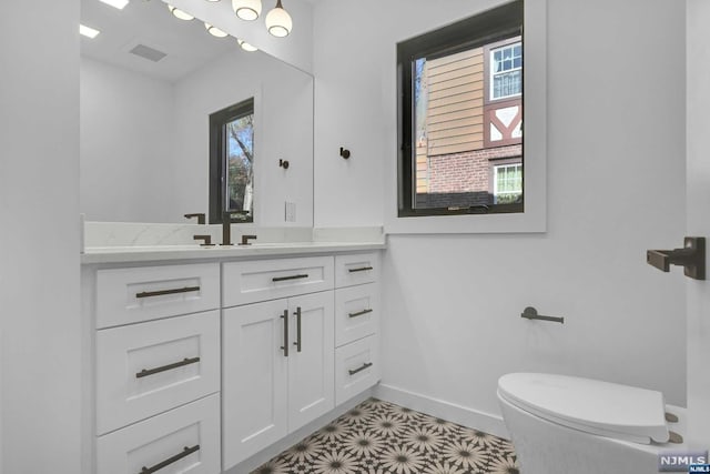 bathroom featuring vanity and toilet