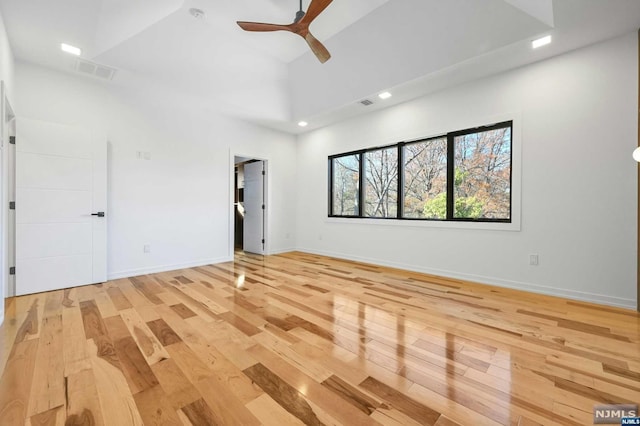 empty room with light hardwood / wood-style flooring and ceiling fan