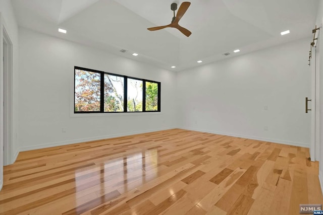 empty room with light wood-type flooring and ceiling fan