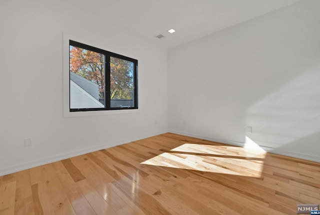 spare room with wood-type flooring