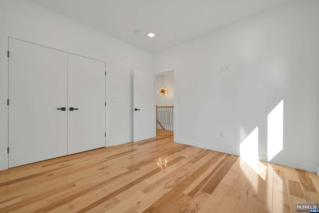 unfurnished bedroom with a closet and wood-type flooring