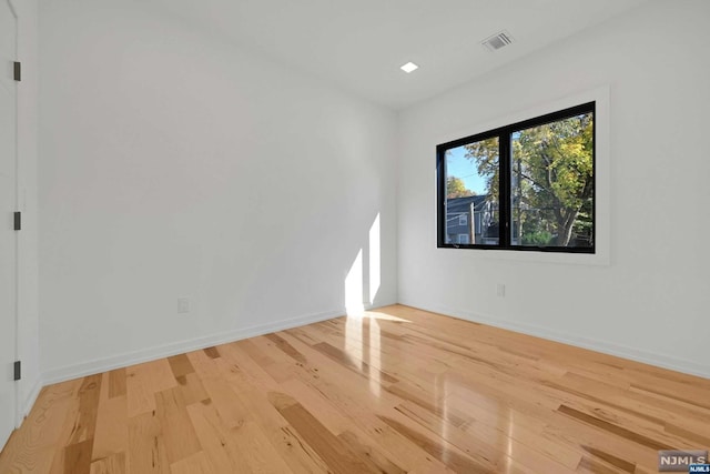 unfurnished room with light hardwood / wood-style flooring