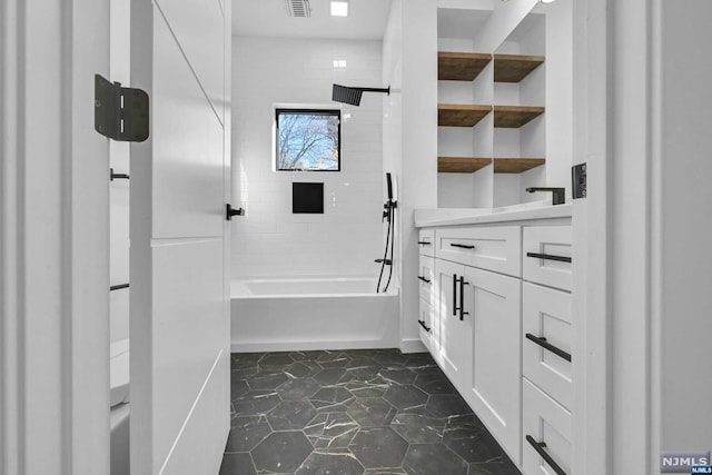 bathroom featuring vanity and tiled shower / bath combo