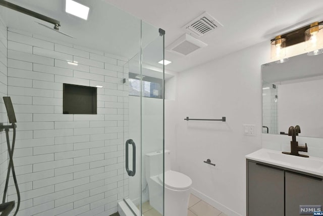 bathroom featuring an enclosed shower, vanity, toilet, and tile patterned floors