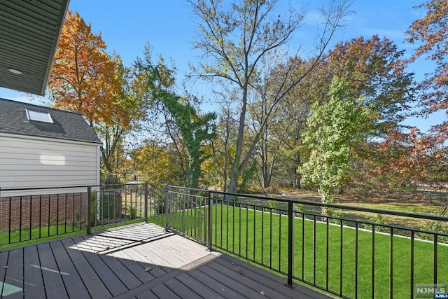 wooden terrace featuring a yard