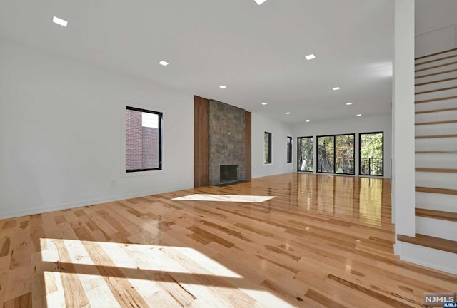 unfurnished living room featuring a fireplace and light wood-type flooring