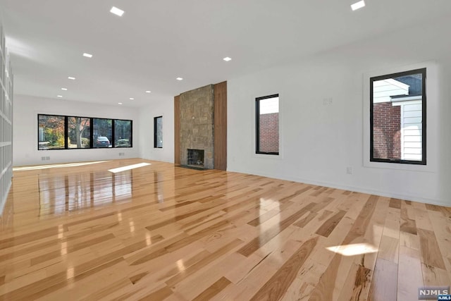 unfurnished living room with a fireplace and light hardwood / wood-style flooring