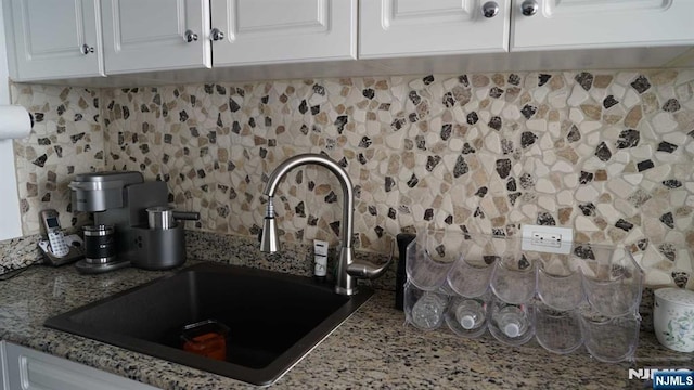 100 Old Palisade Rd Unit 2610, Fort Lee, NJ 07024 - kitchen view of backsplash, white cabinets, and light stone countertops