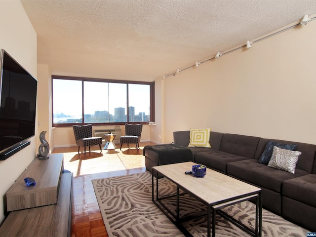 living room with parquet floors and a textured ceiling