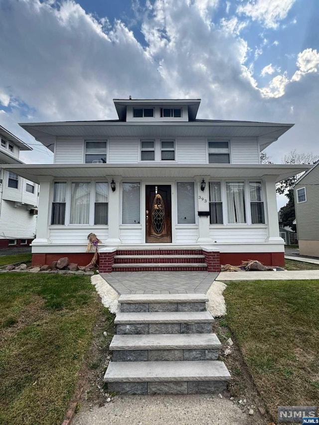 view of front of property with covered porch and a front lawn