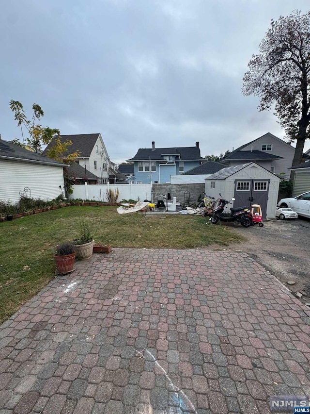 exterior space with a front lawn and a patio area