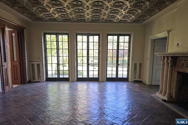 doorway to outside with a fireplace and a wealth of natural light