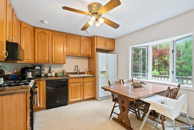 kitchen with sink, light colored carpet, a wealth of natural light, and black appliances