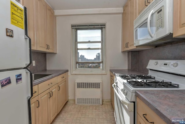 kitchen featuring radiator, light brown cabinets, sink, backsplash, and white appliances