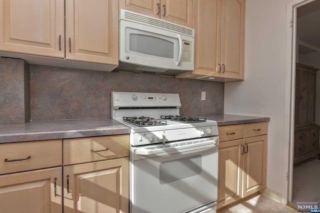 kitchen with white appliances and tasteful backsplash