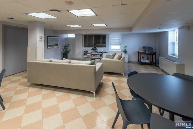 living room with a paneled ceiling