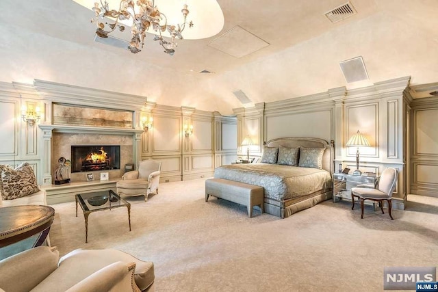 bedroom with a chandelier, a fireplace, high vaulted ceiling, and light colored carpet