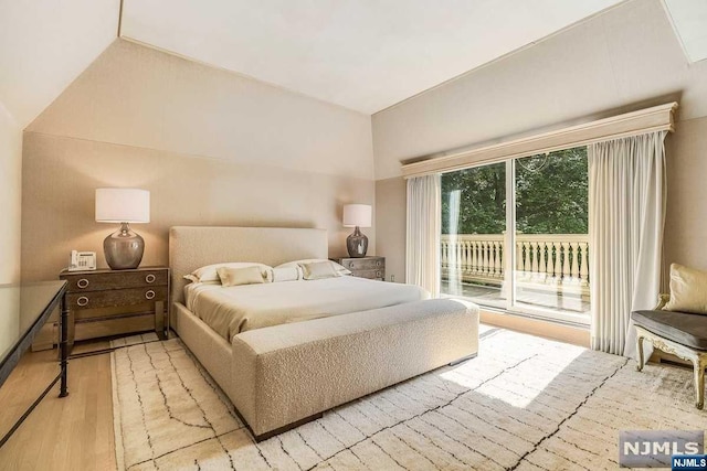 bedroom featuring access to exterior and light hardwood / wood-style flooring