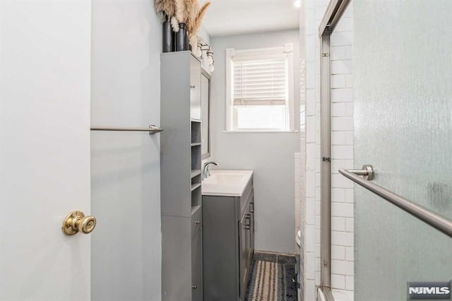 bathroom with vanity and an enclosed shower