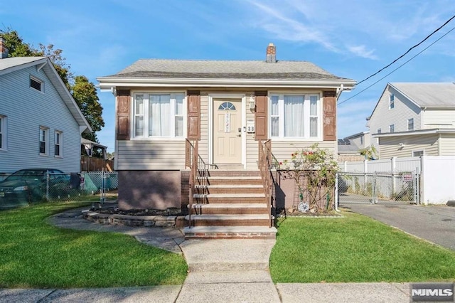 bungalow-style home featuring a front yard