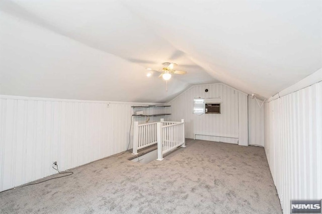 bonus room with ceiling fan, light colored carpet, and vaulted ceiling