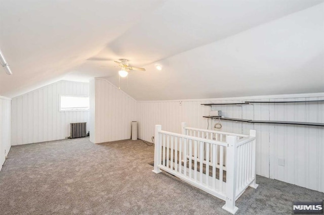 bonus room featuring carpet floors, radiator, lofted ceiling, and ceiling fan