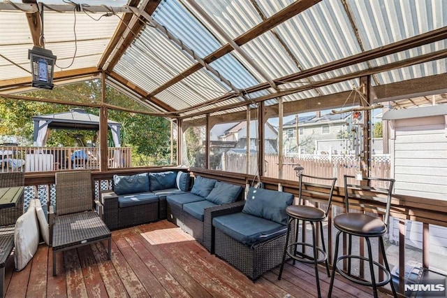 wooden deck featuring a gazebo and an outdoor hangout area