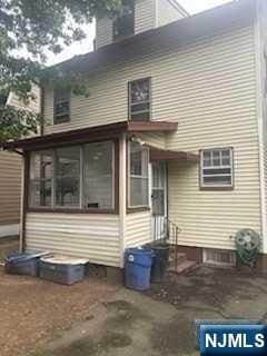 rear view of property with a sunroom