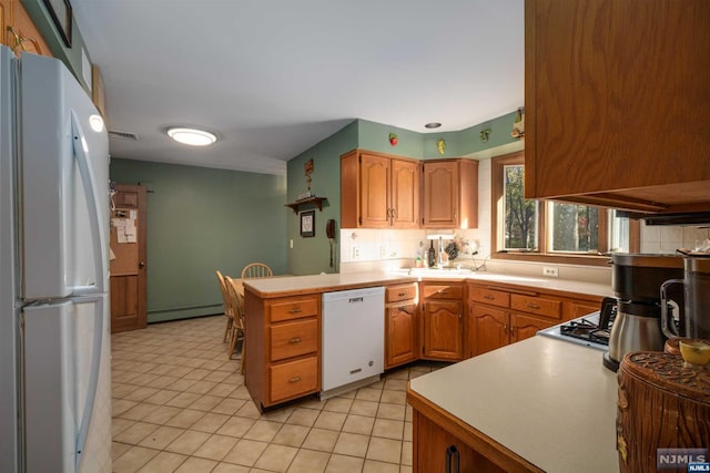 kitchen with white appliances, premium range hood, tasteful backsplash, a baseboard radiator, and kitchen peninsula