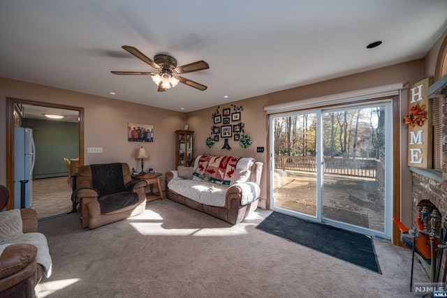 interior space featuring light colored carpet, white fridge, ceiling fan, access to exterior, and a baseboard heating unit