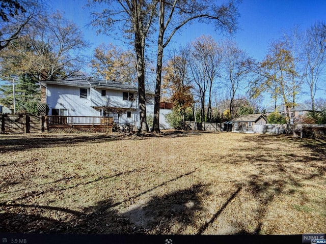 view of yard featuring a wooden deck