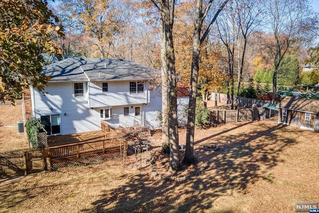 view of yard with a deck and a storage shed