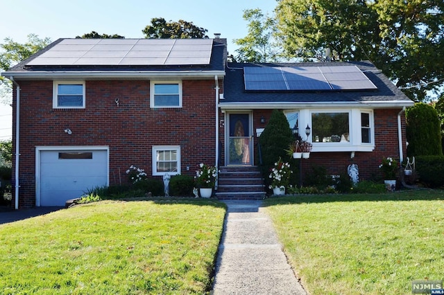 view of front facade with solar panels, a front lawn, and a garage