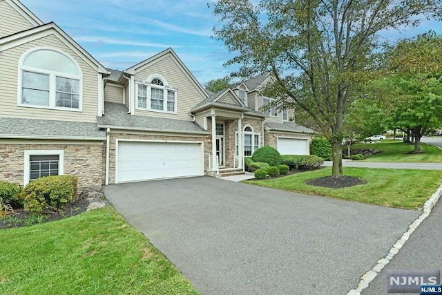 view of front facade with a front lawn and a garage