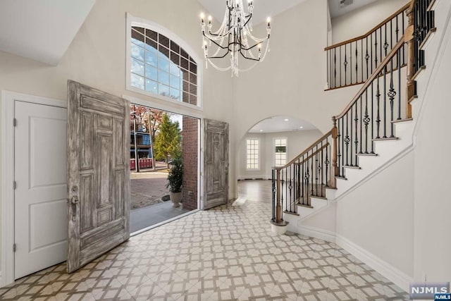 foyer with a chandelier and a high ceiling