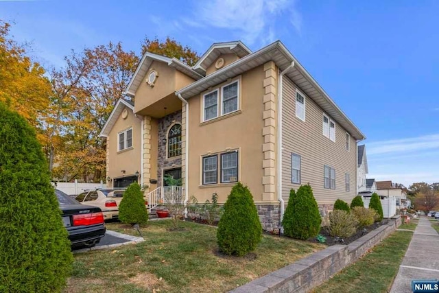 view of home's exterior featuring a lawn and a garage