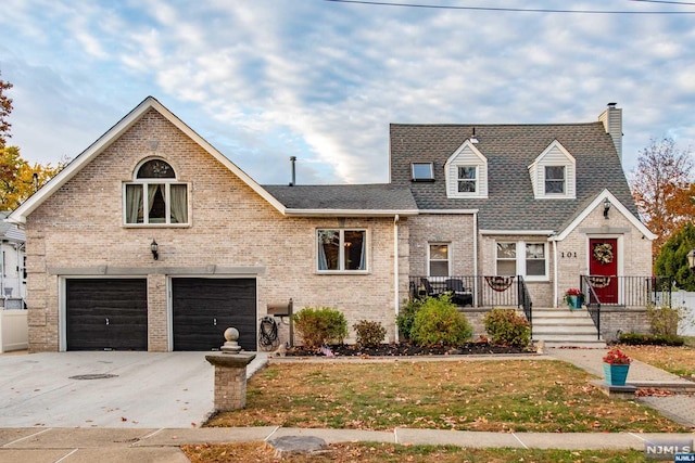 view of front of house featuring a garage and a front lawn