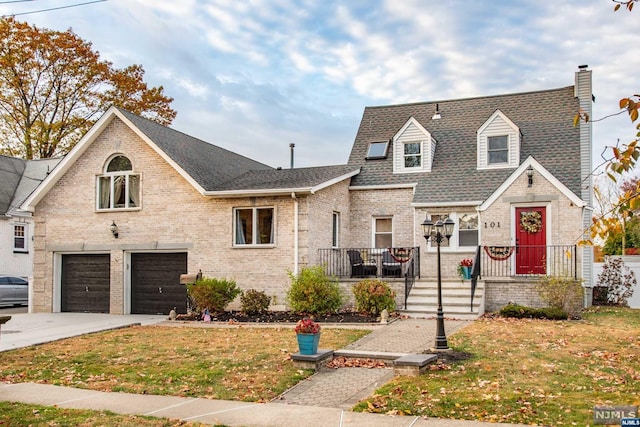 view of front of house with a front yard and a garage