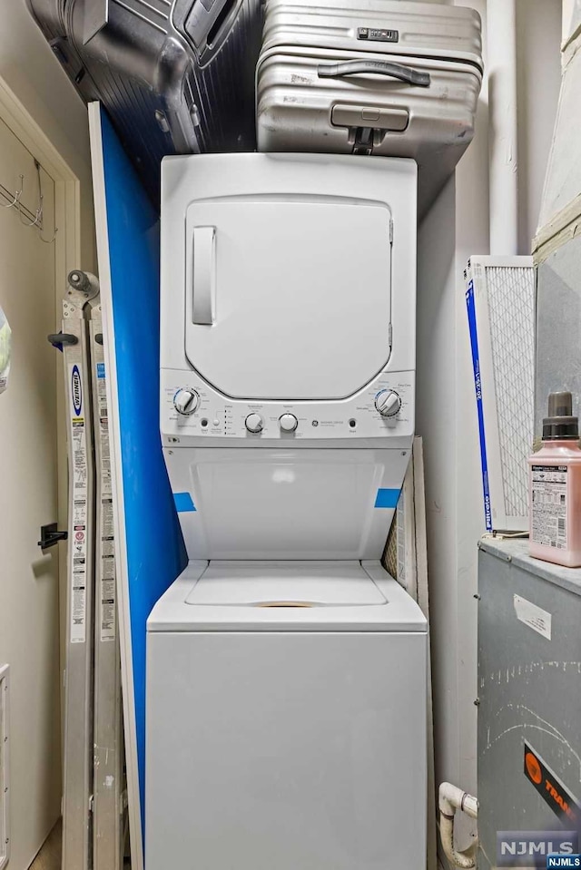 laundry room with stacked washer / dryer